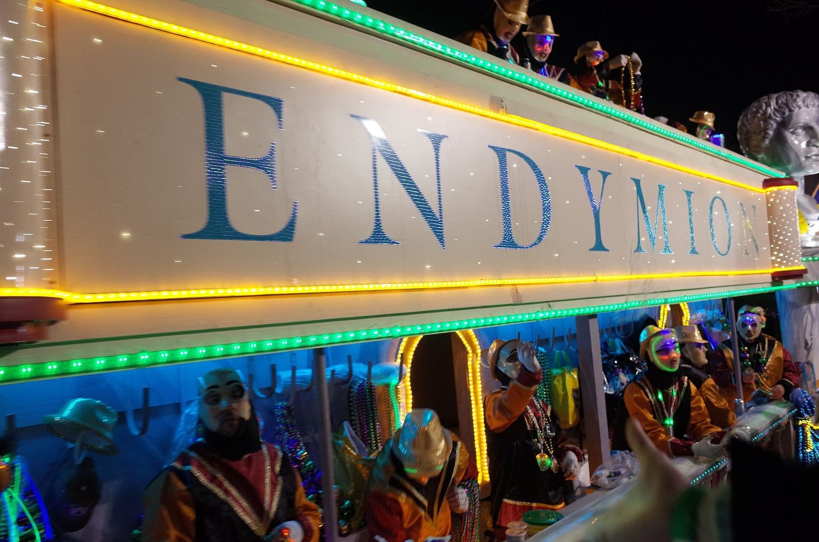 The illuminated Endymion float, its name spelled out in lights, with masked riders aboard during the night parade in New Orleans
