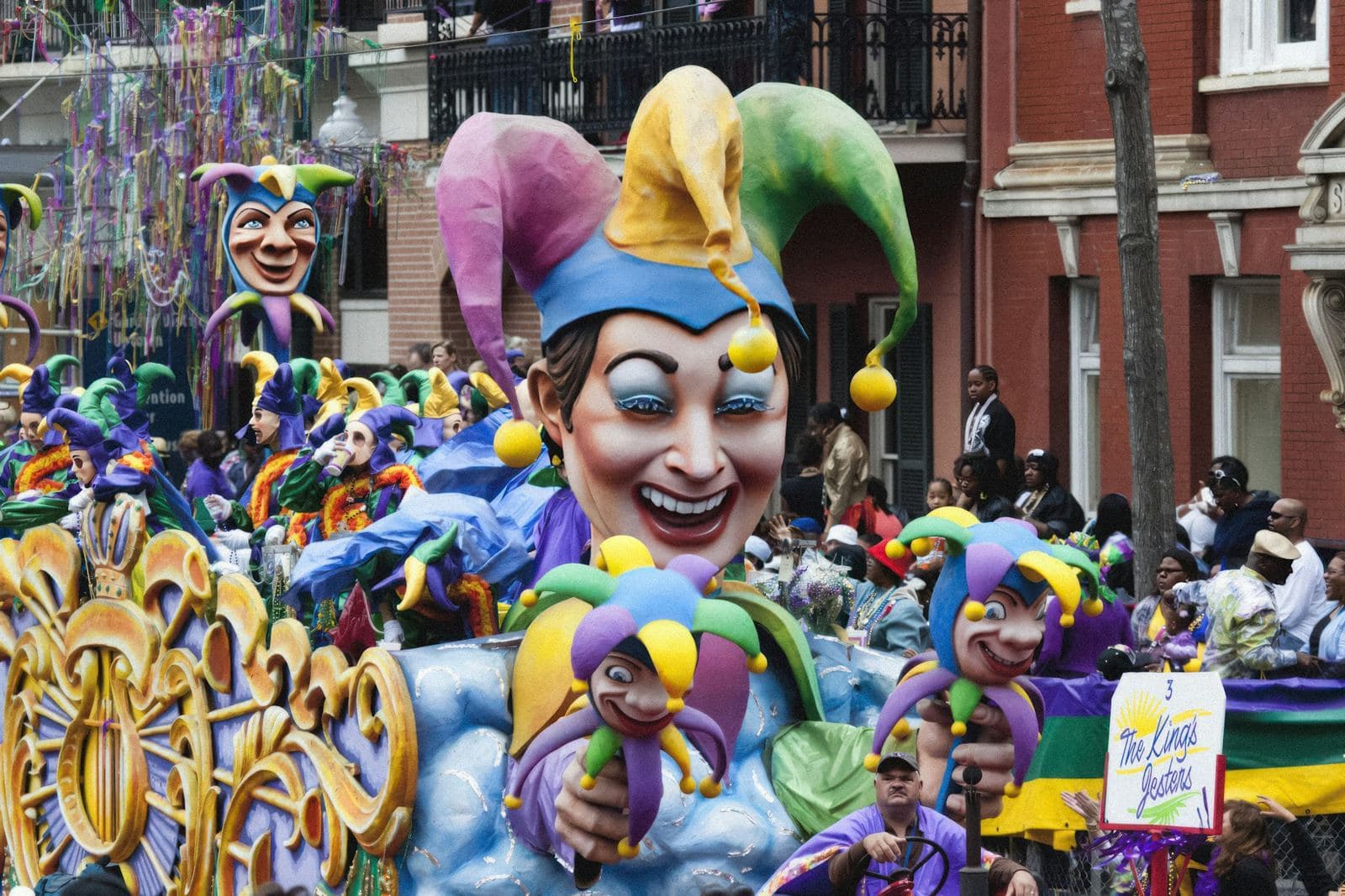 Colorful Mardi Gras parade float rolling through New Orleans during Carnival season, surrounded by crowds